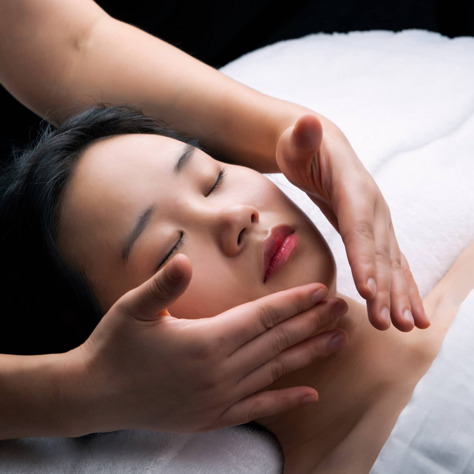 Guest laying on a spa table and getting a facial.