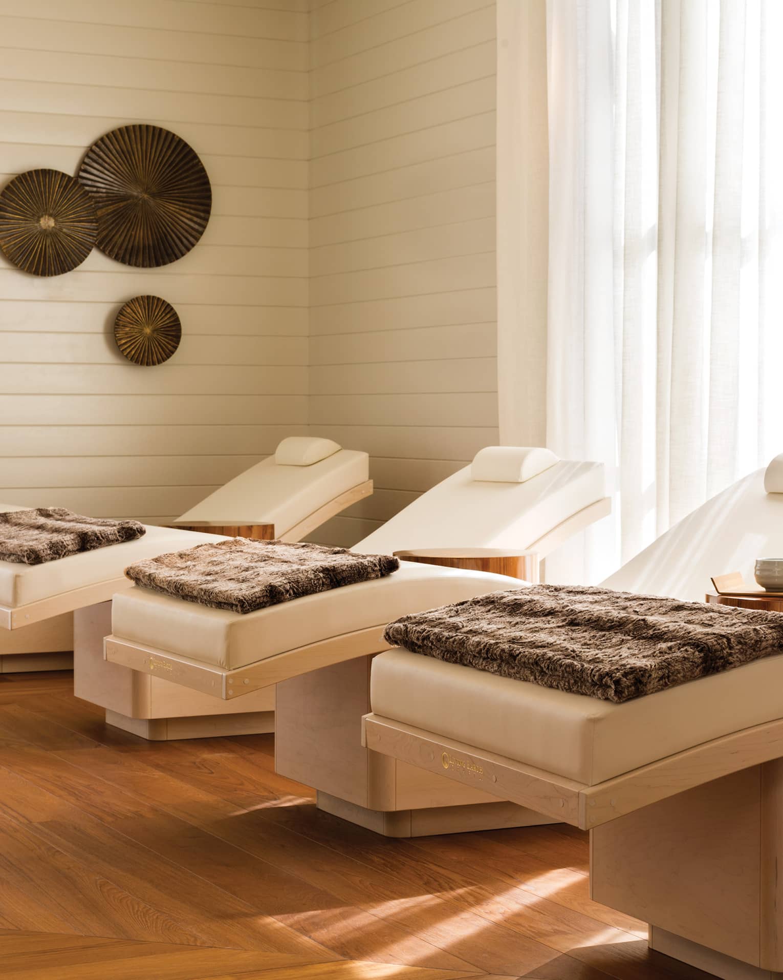 Spa chairs in a room with floor-to-ceiling windows