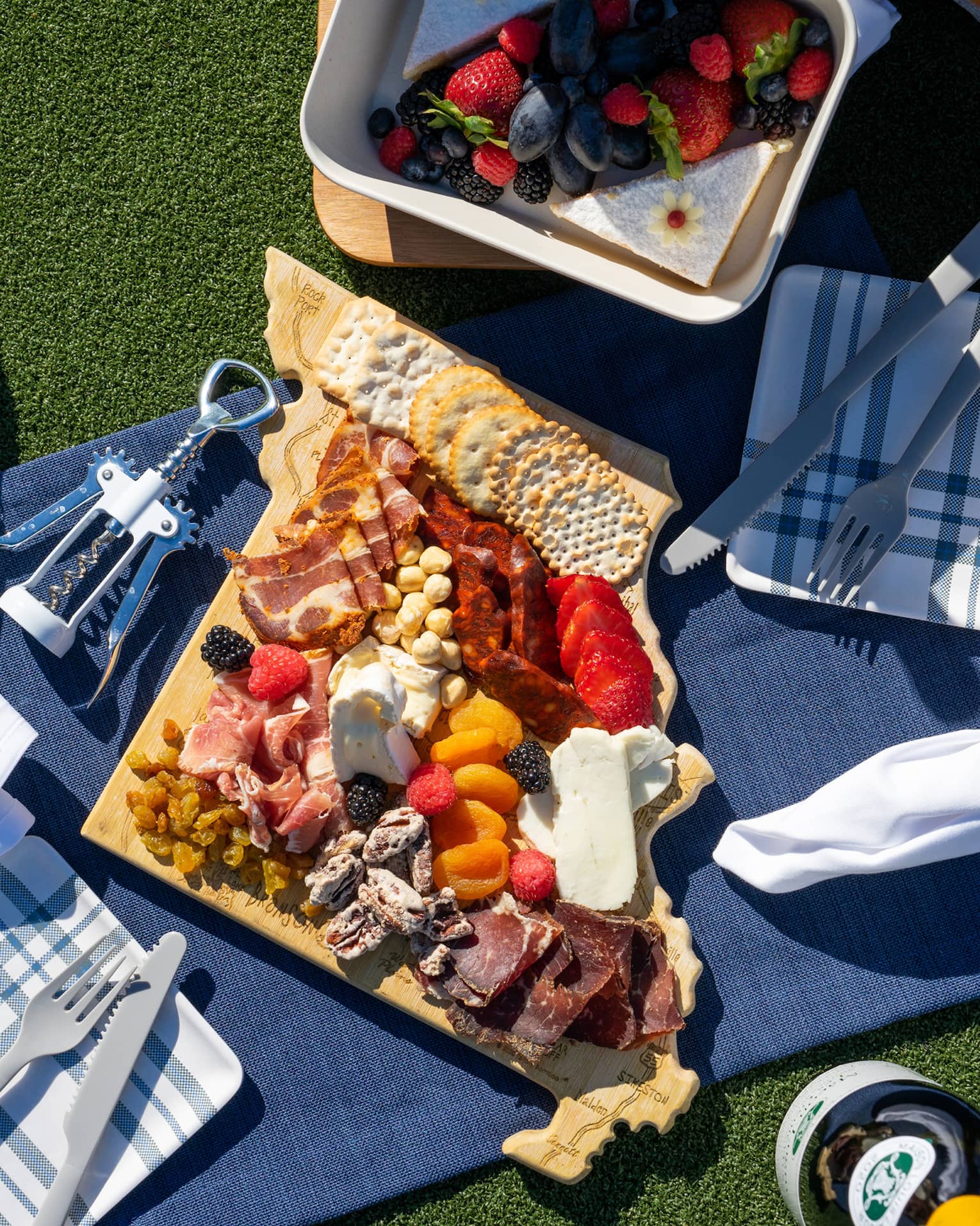 A picnic blanket covered in charcuterie.