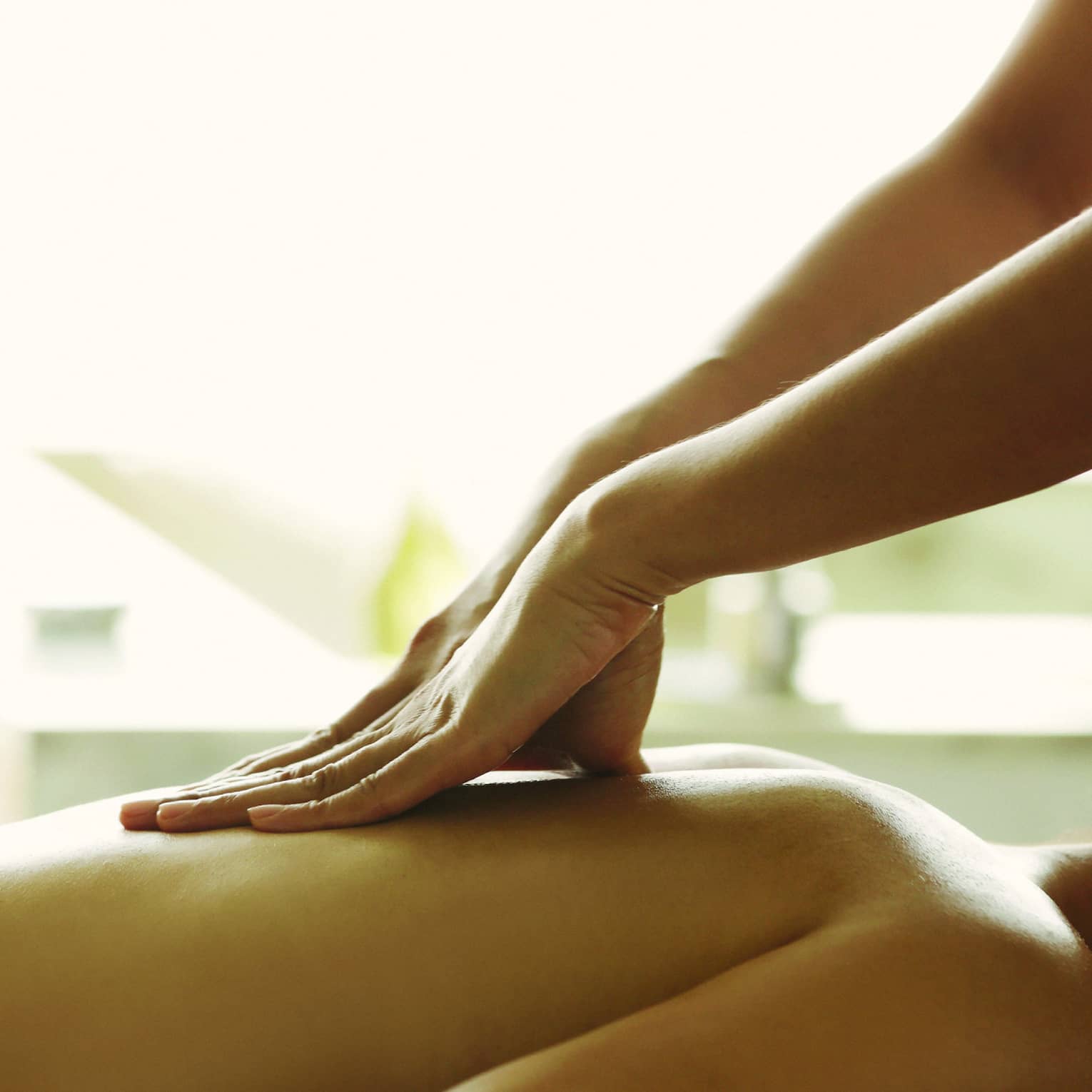 Close-up of a person receiving a relaxing back massage in a spa setting.