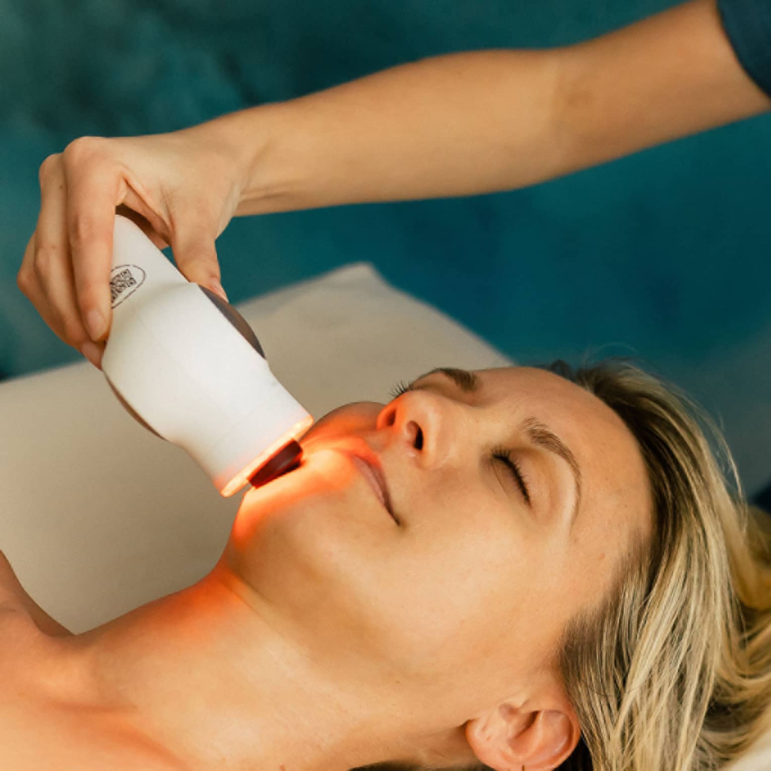 Woman gets a laser treatment on her face at a spa