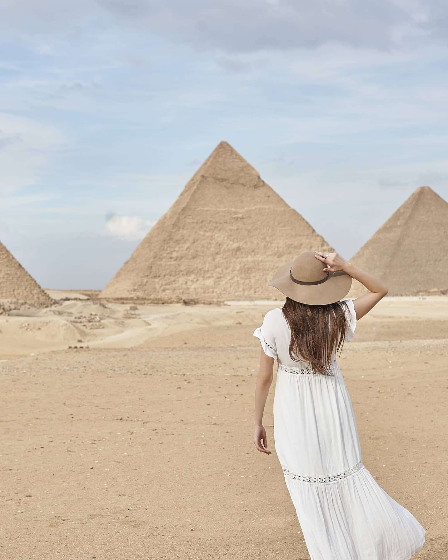 A guest wearing a linen dress observing the Great Pyramids