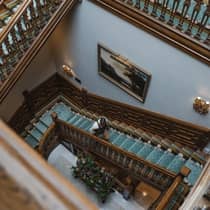 Aerial view of a man ascending a spiral wooden staircase