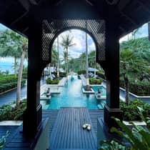 View of hotel pool from underneath breezeway