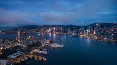 Aerial view of Hong Kong waterfront, city buildings and lights at night