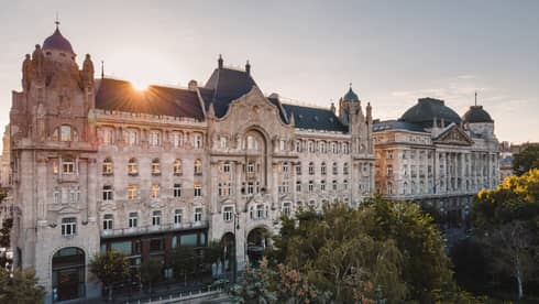 A large stone building with trees surrounding it.