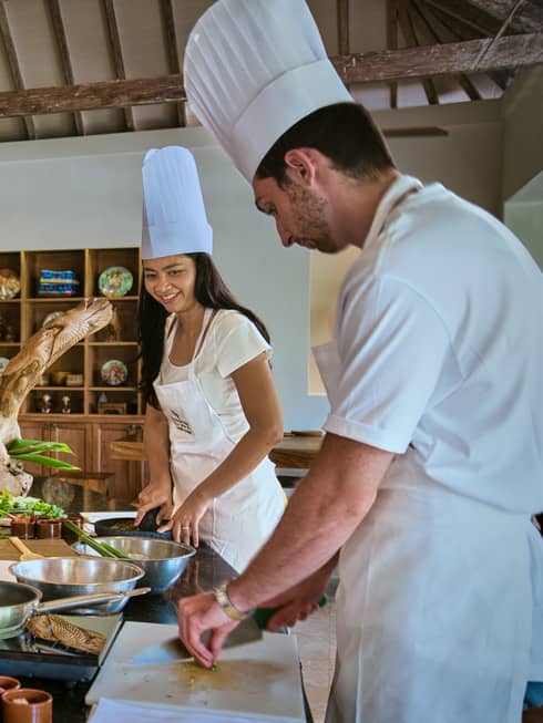 Two guests receive cooking lesson at Four Seasons hotel