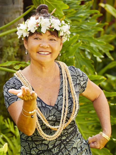 A woman practices hula with a flower crown