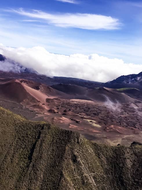 A dormant volcano crater sits above the clouds at Haleakala National Park