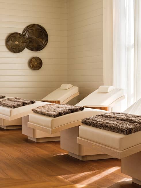 Spa chairs in a room with floor-to-ceiling windows