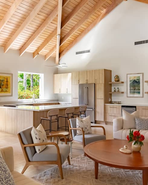 A kitchen and living room area with wooden cabinets and ceiling
