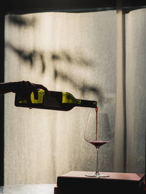 Red wine being poured into a wine glass
