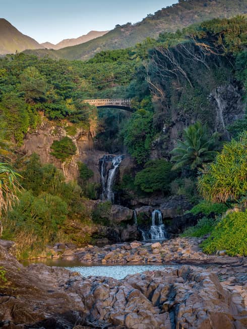 Waterfalls tumble beneath the Road to Hana as they make their way to Maui’s Seven Sacred Pools