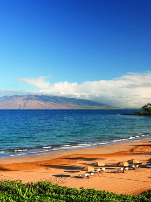 The golden sands of Wailea Beach with the volcanic slopes of Maui in the background