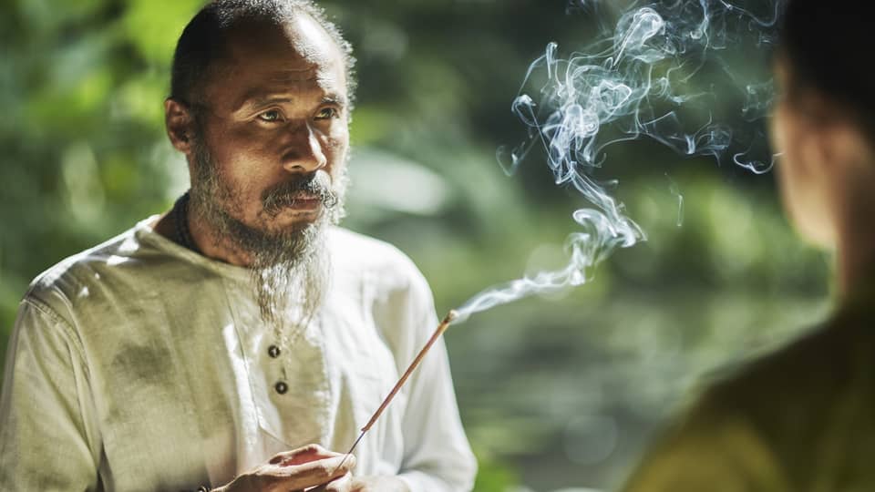 Balinese healer with burning incense