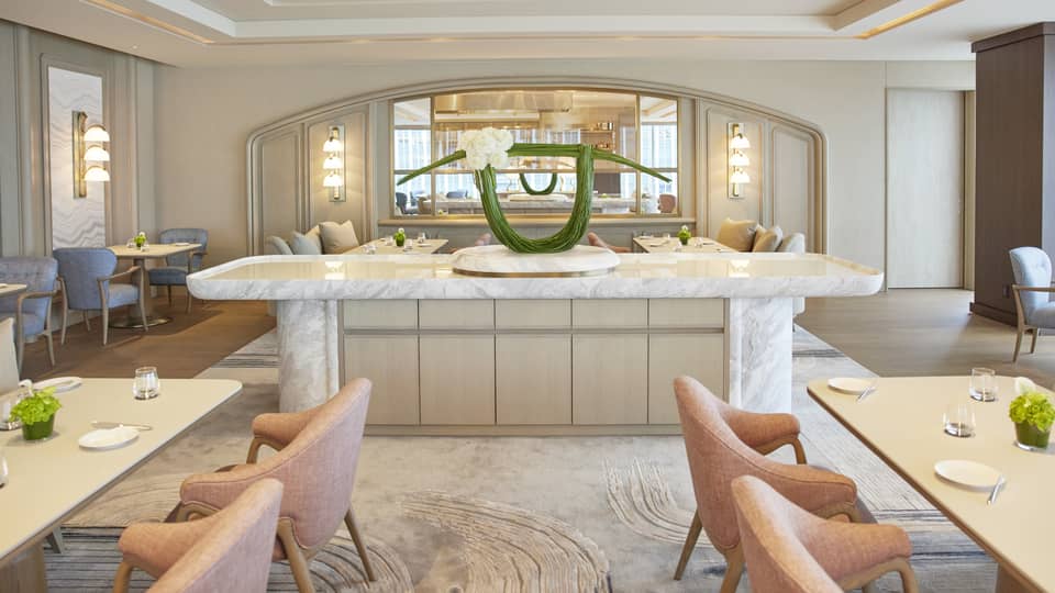 Four Seasons dining area with a marble counter and a modern floral arrangement in a light, stylish interior