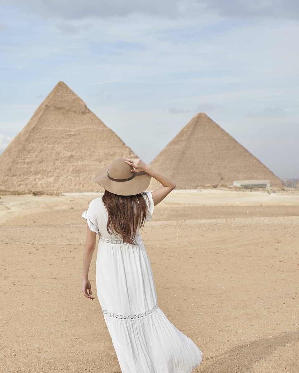 A guest wearing a linen dress observing the Great Pyramids
