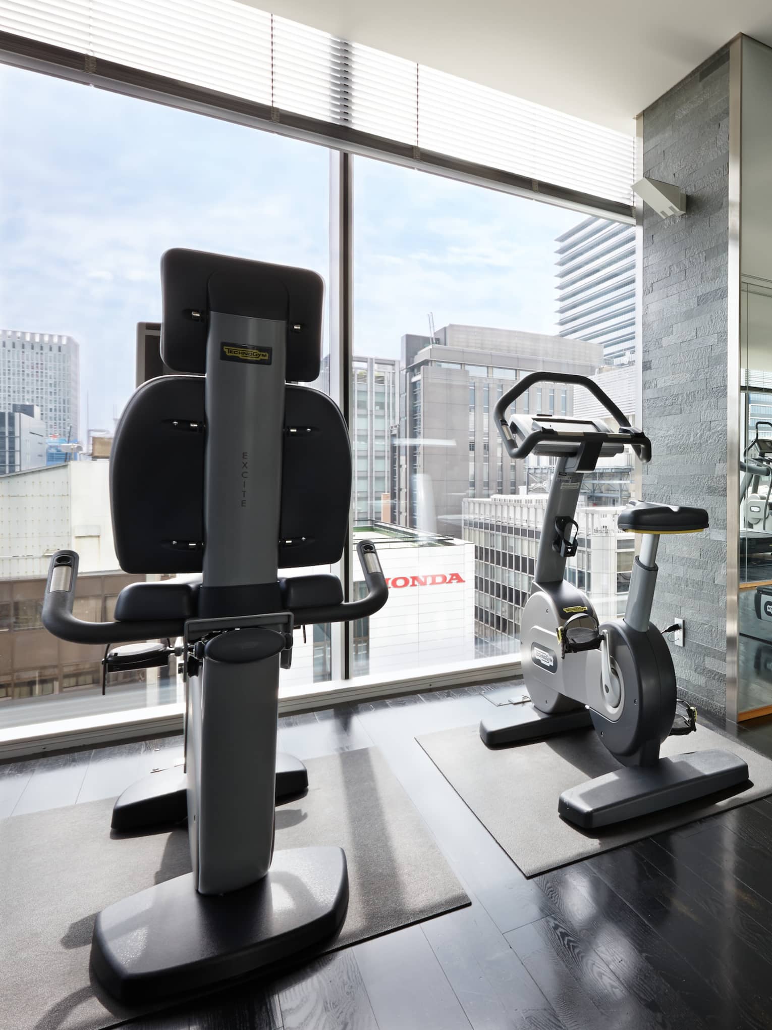 Elliptical machines, treadmills, cardio equipment by sunny window in Fitness Centre