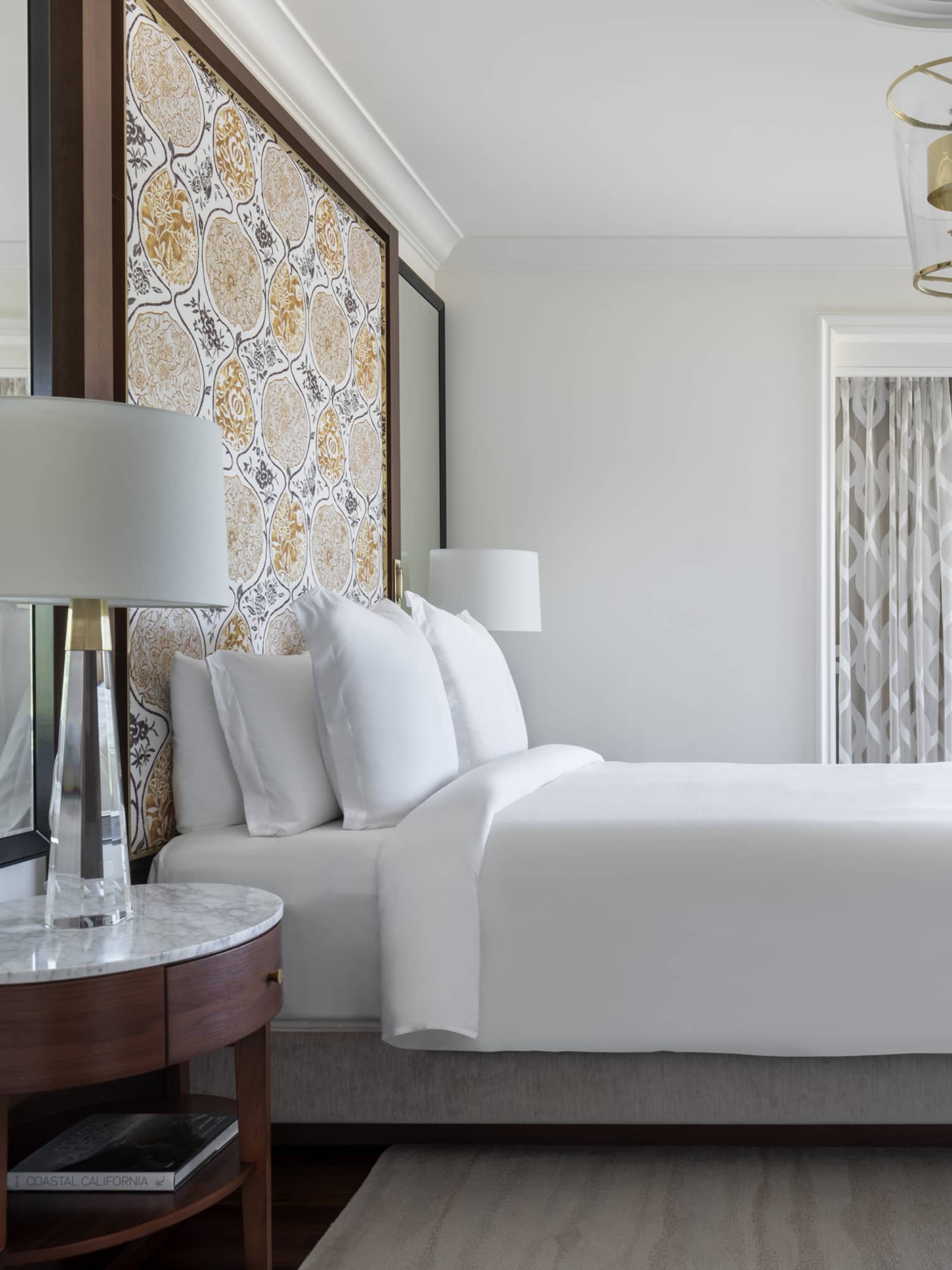 The bed and loveseat of a Malibu Corner One-Bedroom Suite.