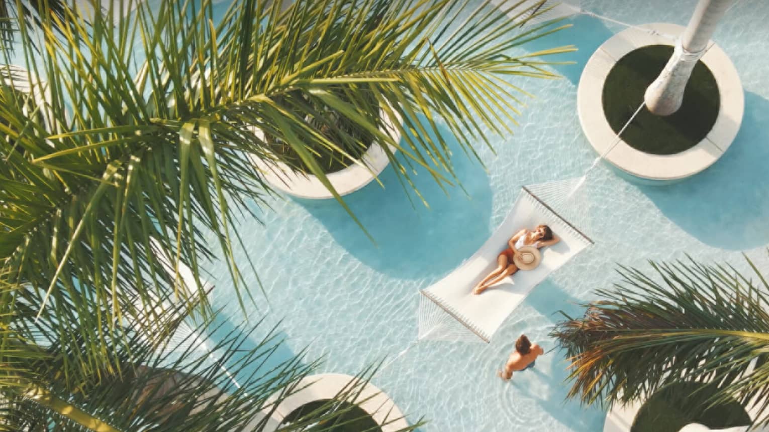 A person crossing a bridge in front of a spa