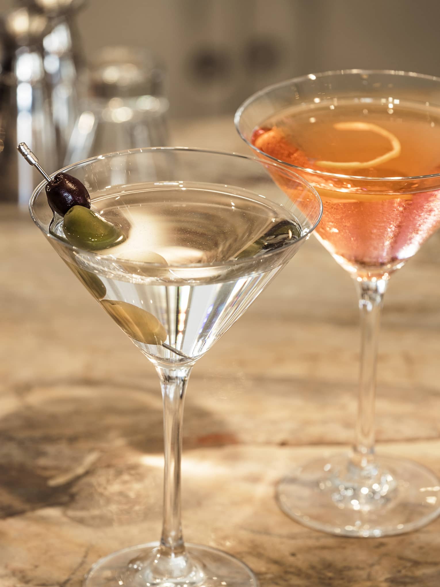 Two cocktails on a counter.