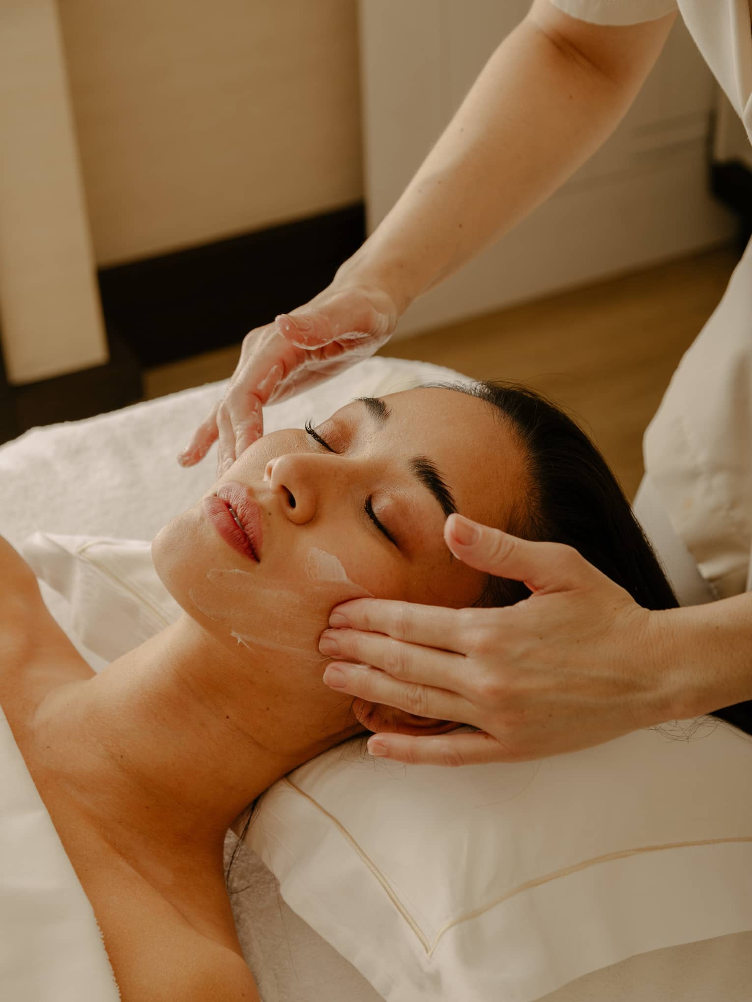 Close up of woman's face getting a facial