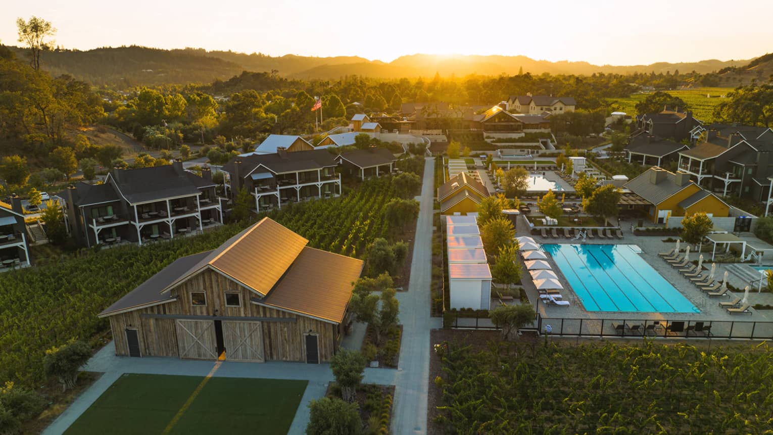 Aerial view of Four Seasons Resort Napa Valley grounds, including pool and vineyards