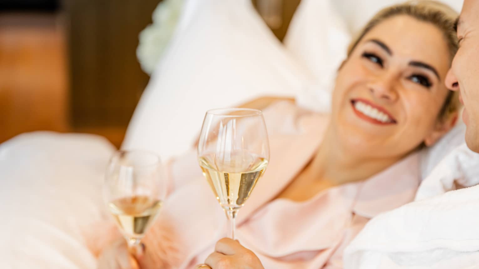 A woman and man resting with wine in hand.