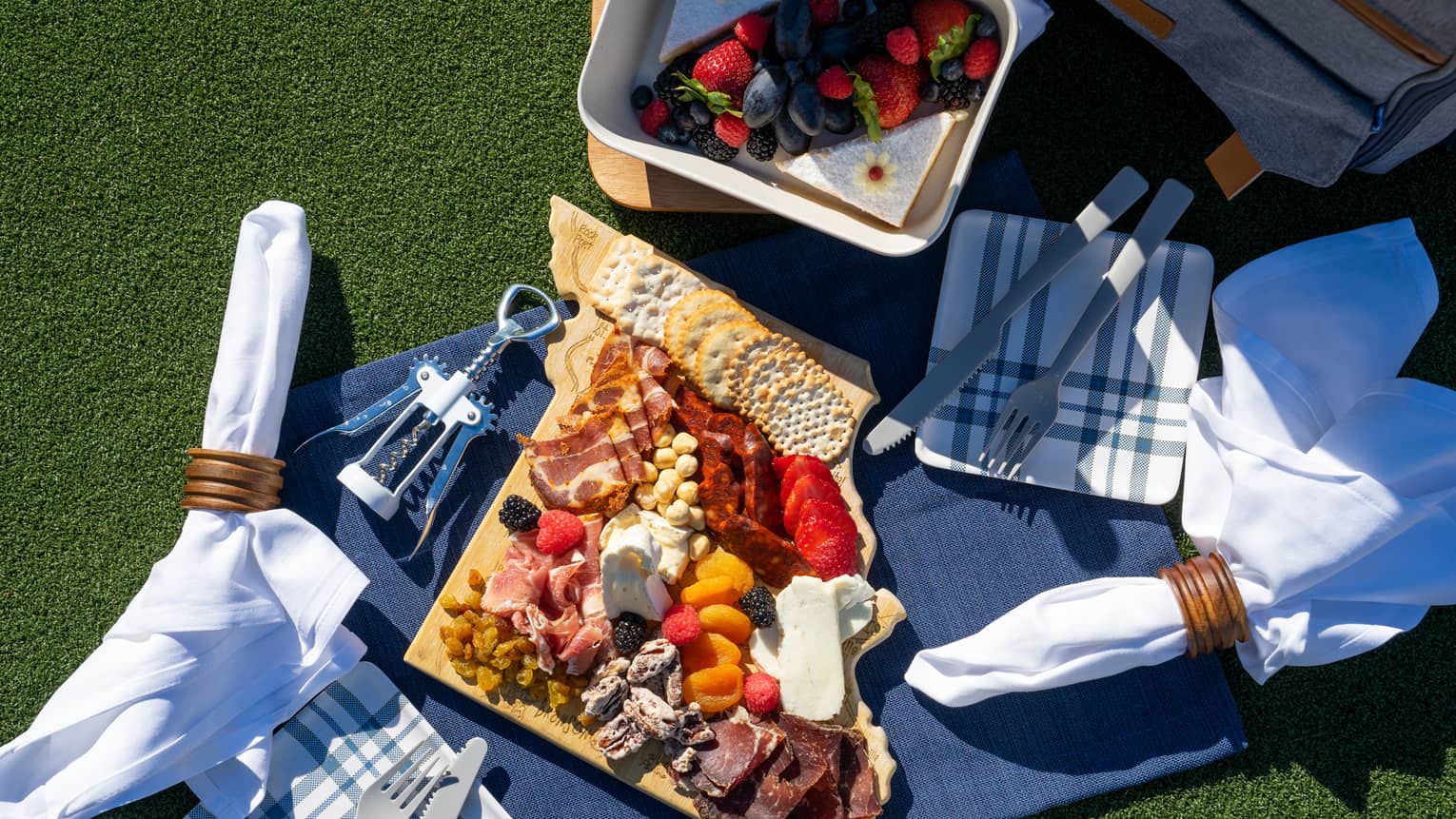A picnic blanket covered in charcuterie.
