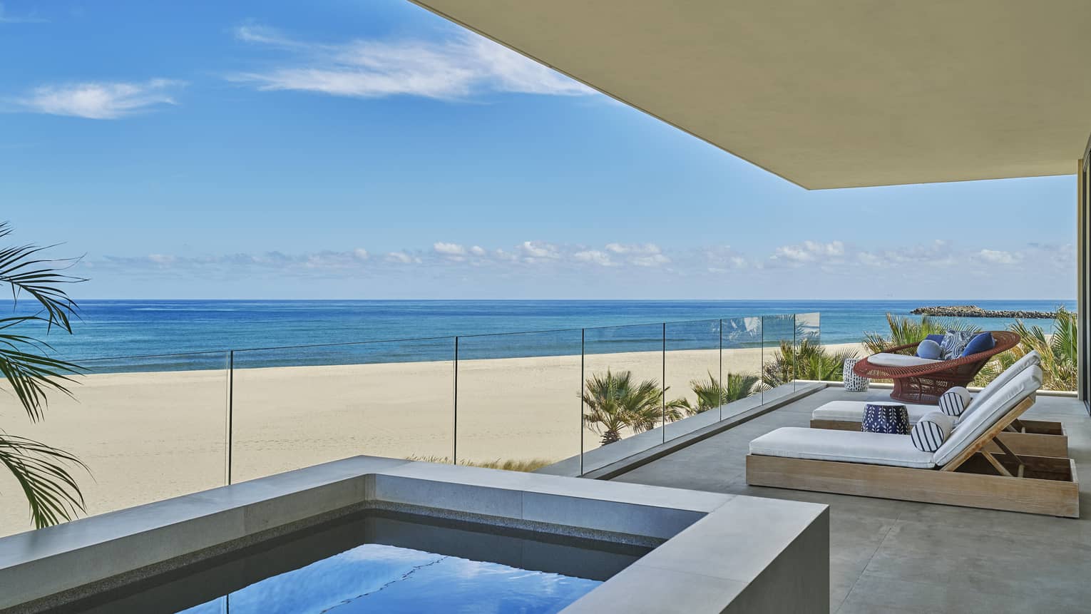 Private luxury villa terrace with glass balcony and plunge tub, looking out to the sea and beach, at Four Seasons Resort and Residences Los Cabos