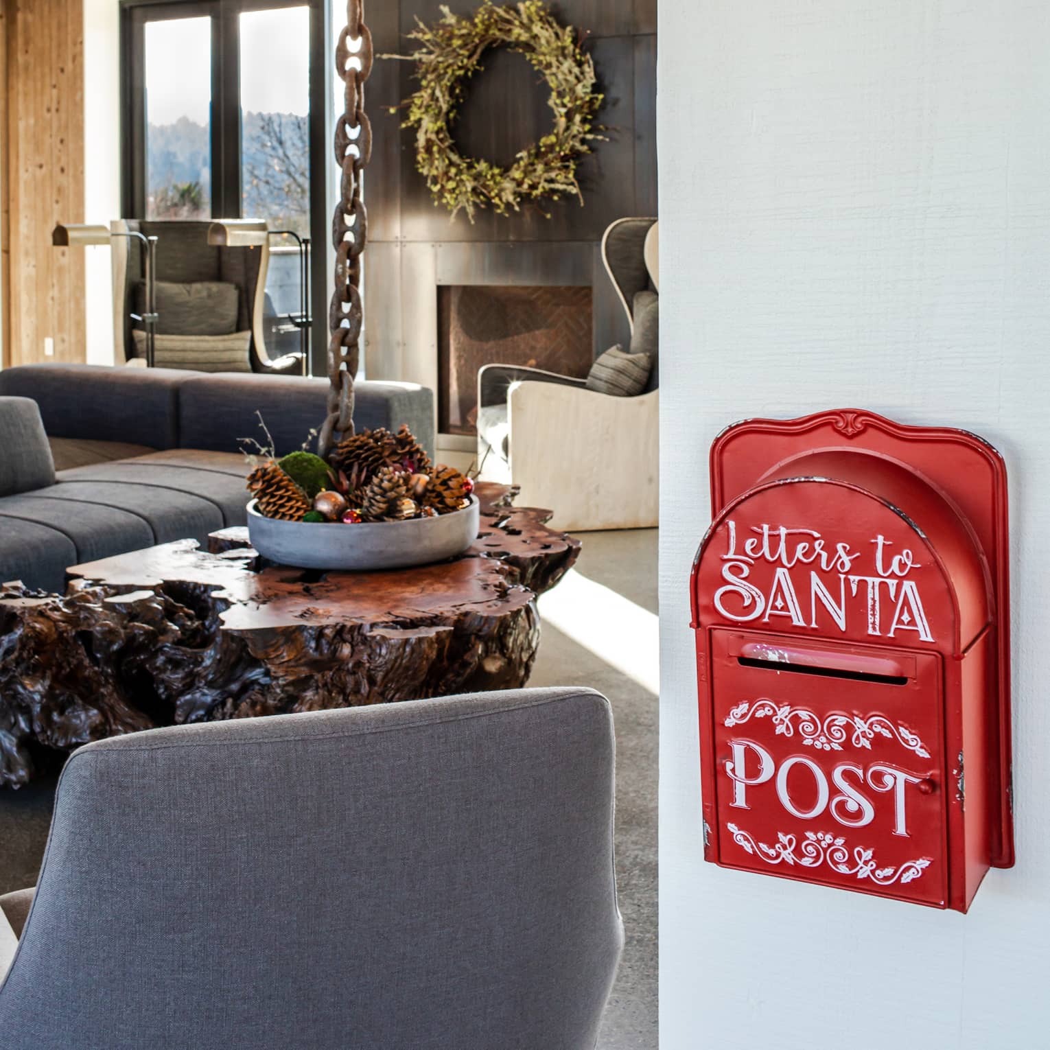 Living room with gray couches and chairs and a red "Letters to Santa" mail box.