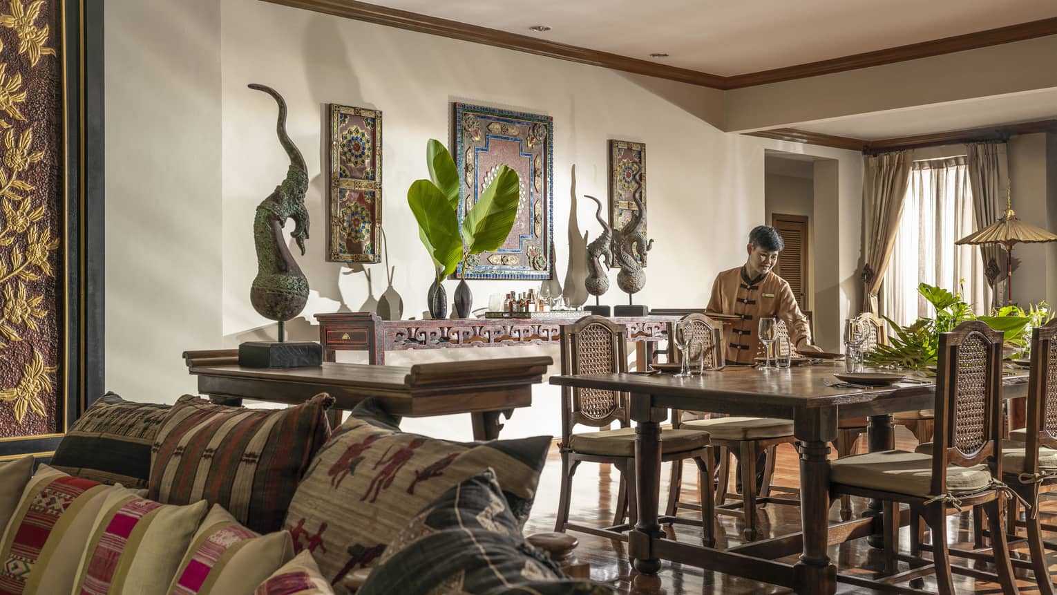 Staff sets dining table at One-Bedroom Spa Residence