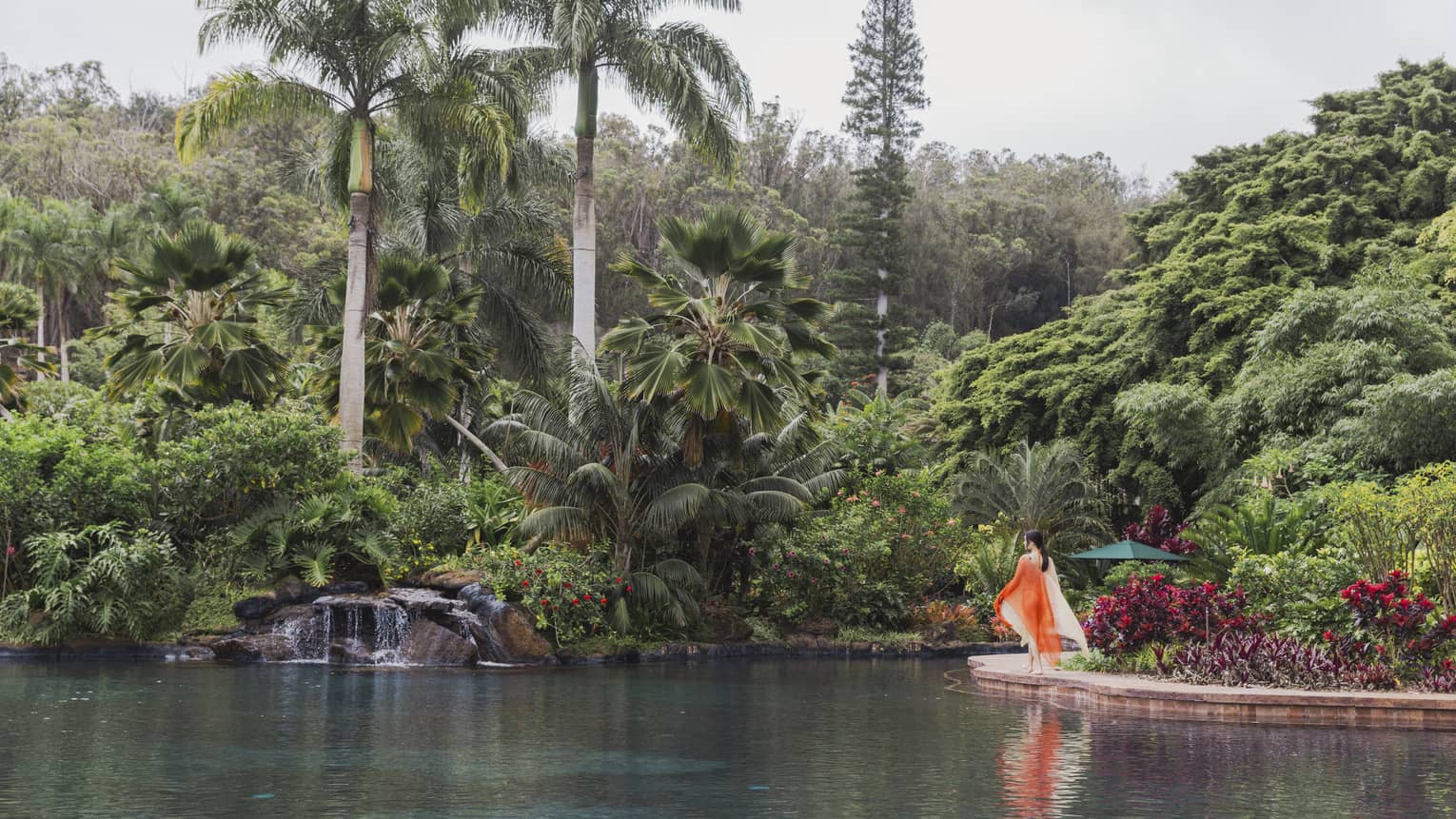 A person crossing a bridge in front of a spa