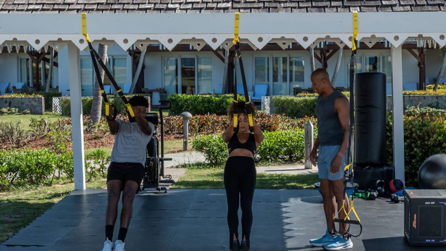 People doing an outdoor fitness class with stretch bands