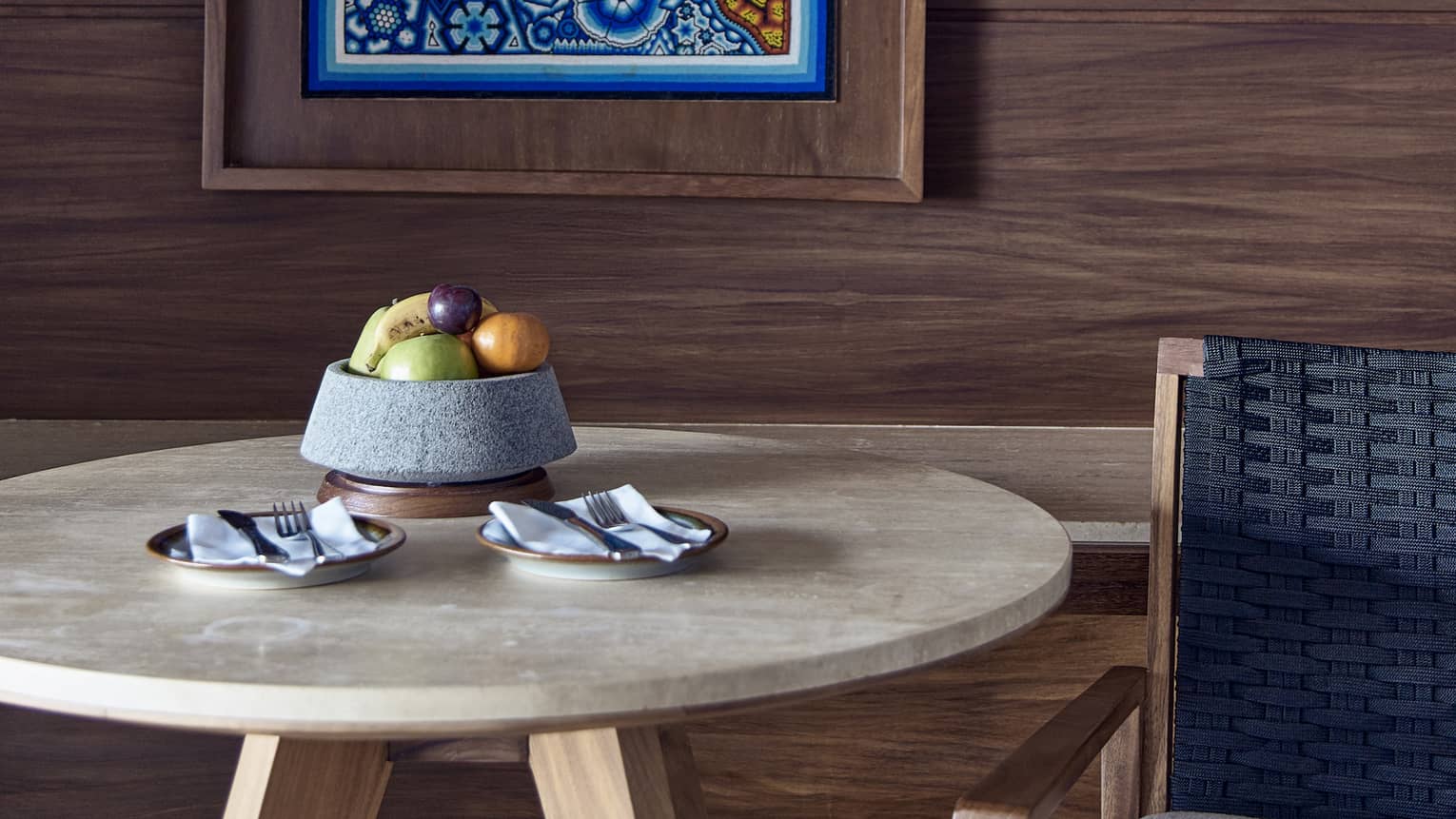 A guest room at Four Seasons Resort in Punta Mita, near Puerto Vallarta, featuring a table with fruit bowl and a locally inspired artwork on the wall