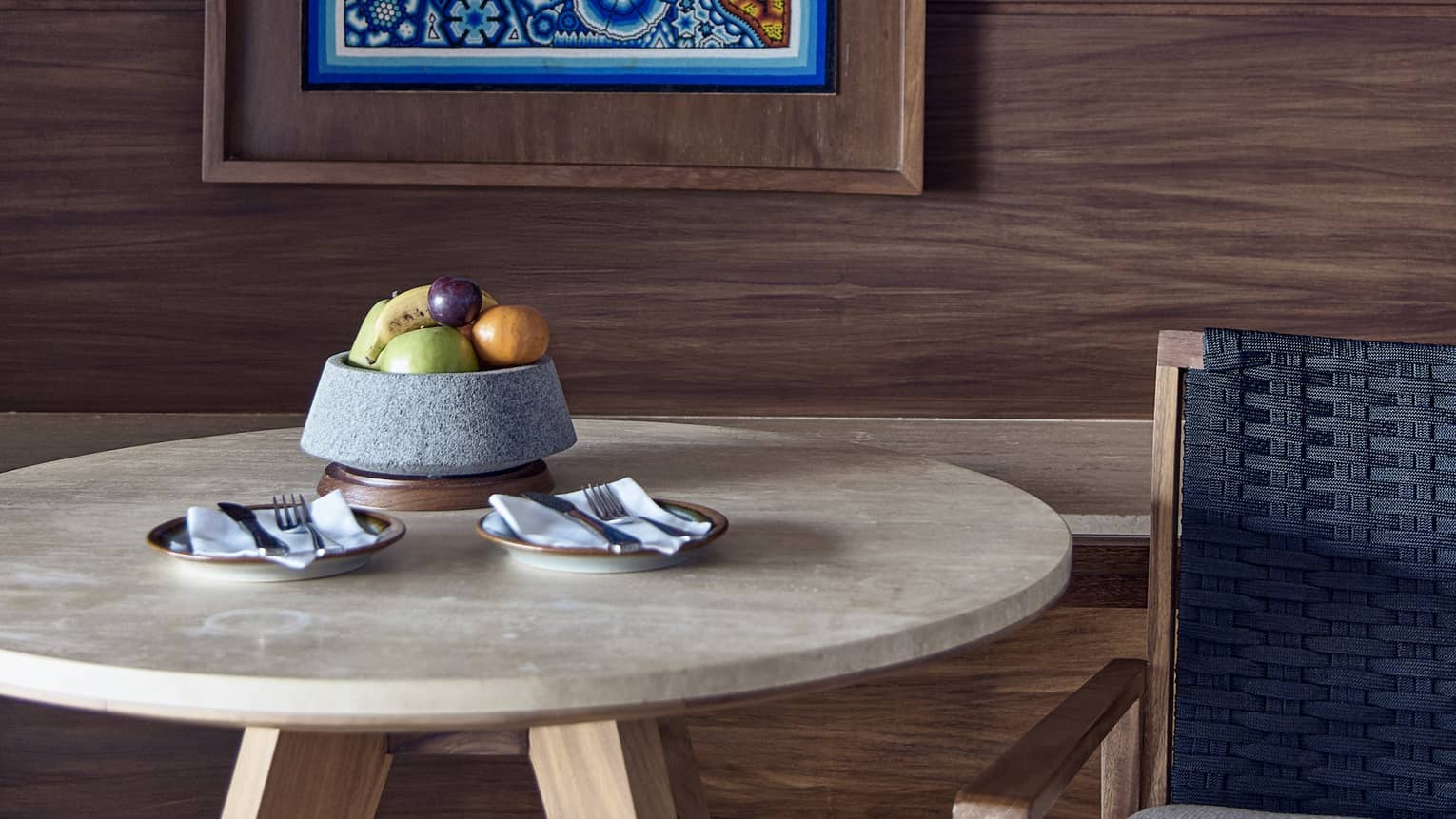 A guest room at Four Seasons Resort in Punta Mita, near Puerto Vallarta, featuring a table with fruit bowl and a locally inspired artwork on the wall