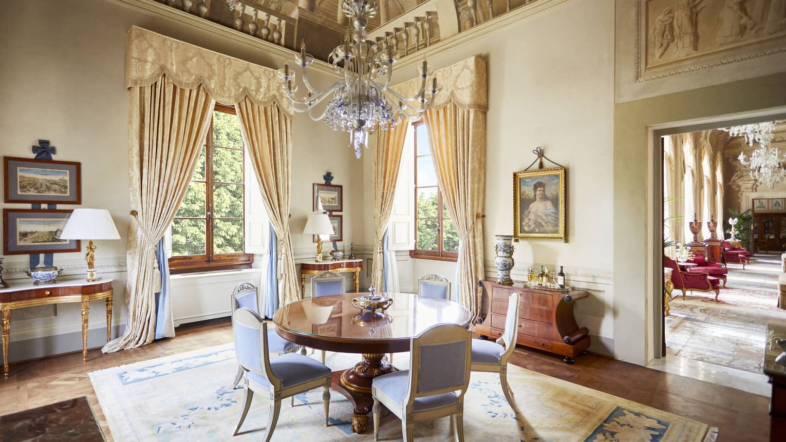 Royal Suite dining room with round table six upholstered chairs, frescoed ceiling with chandelier, at Four Seasons Hotel Florence