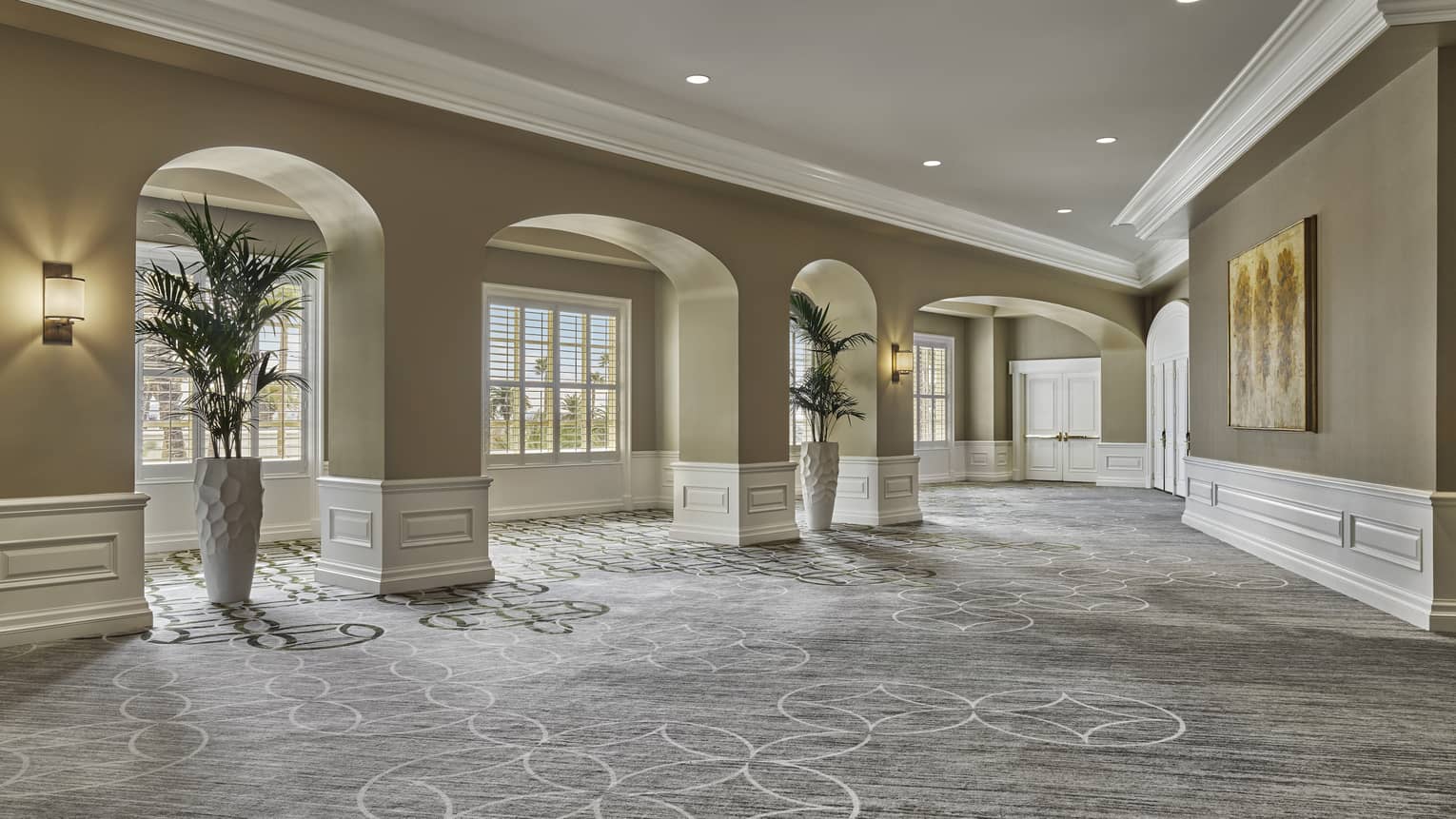 Event space indoor foyer with grey and white carpeting, and taupe-coloured walls