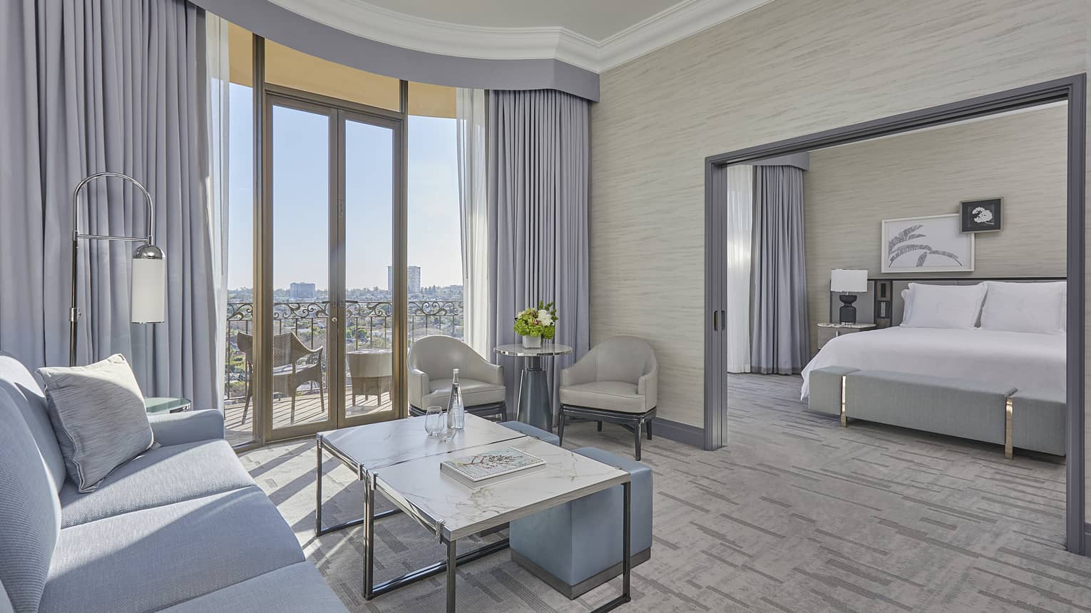 Hotel suite living room with balcony and separate bedroom