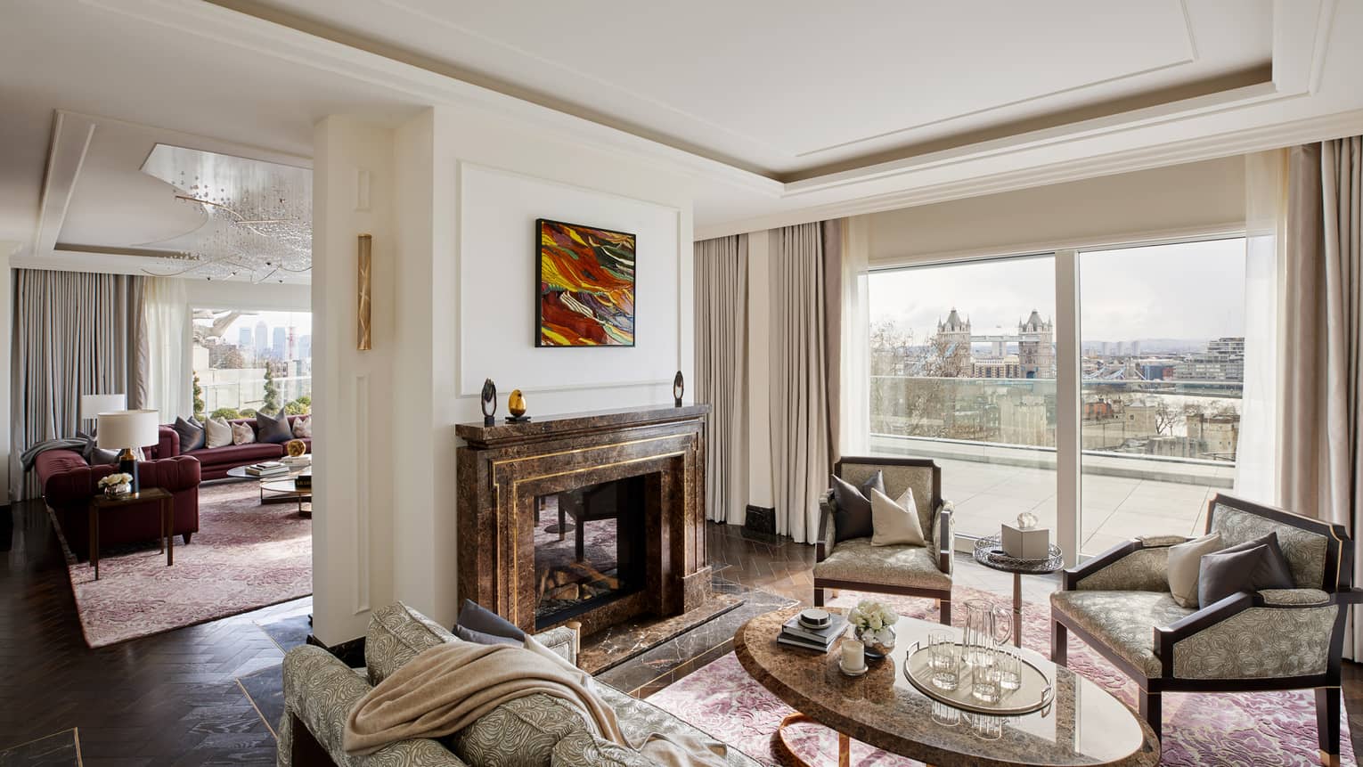 Elegant residence living room with fireplace and tall windows with river views