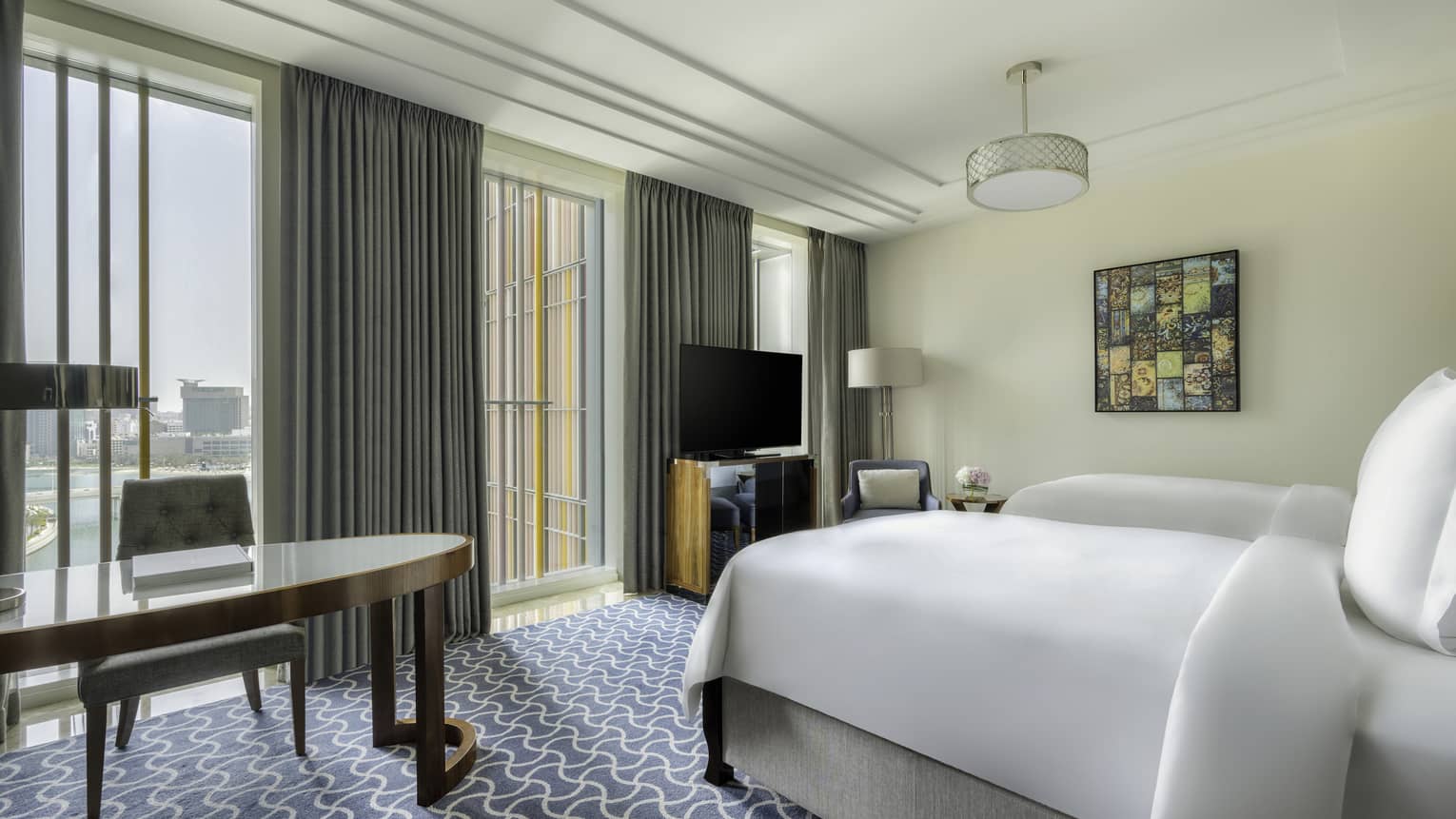 Hotel room with two beds and desk