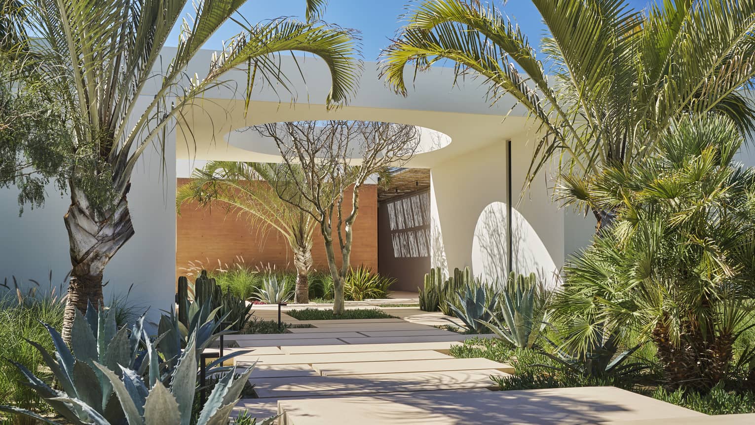 Contemporary entrance to luxury villa with lush tropical landscaping