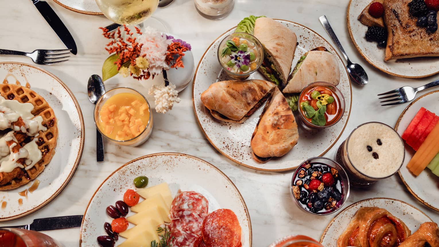 Breakfast dishes included charcuterie, waffles and french toast on a table