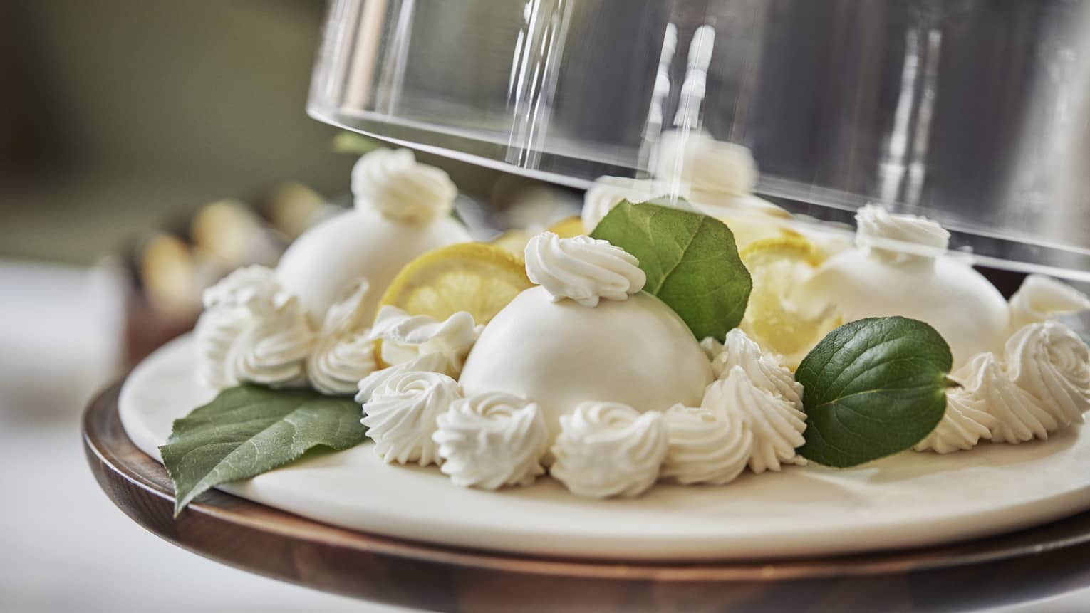 A brunch dish on a platter with lemon slices and leafy greens