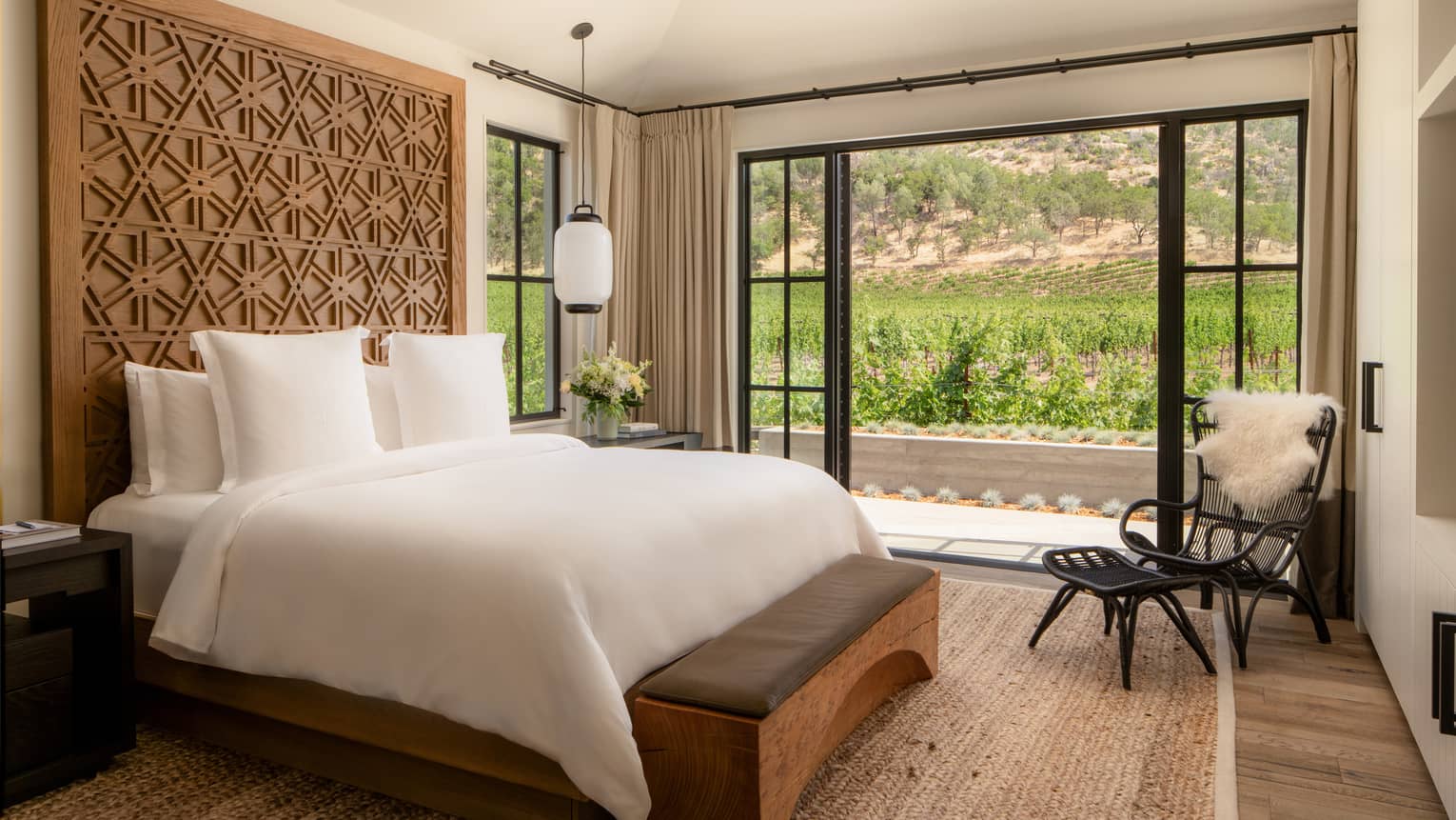 Farmhouse chic, contemporary bedroom with king bed and walk-out terrace with vineyard view