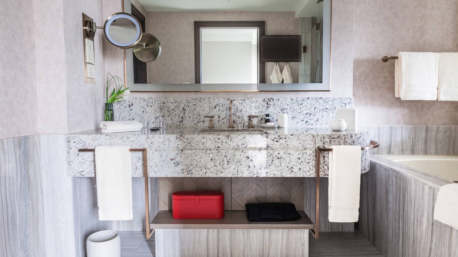 Luxury hotel suite bathroom with marble floors and bath tub
