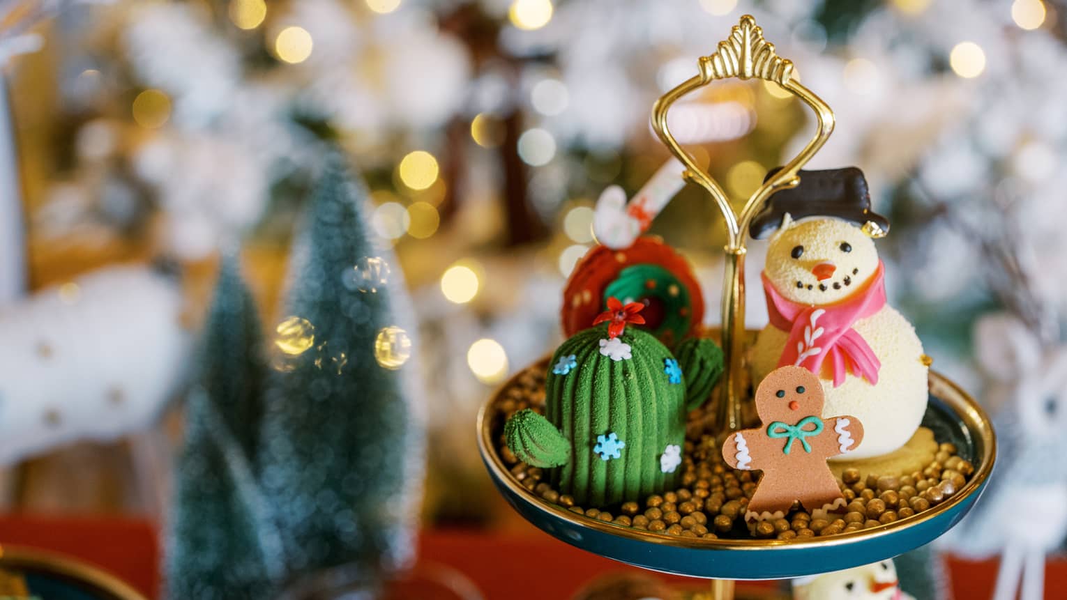 A display with a snowman and gingerbread man and lights in the background
