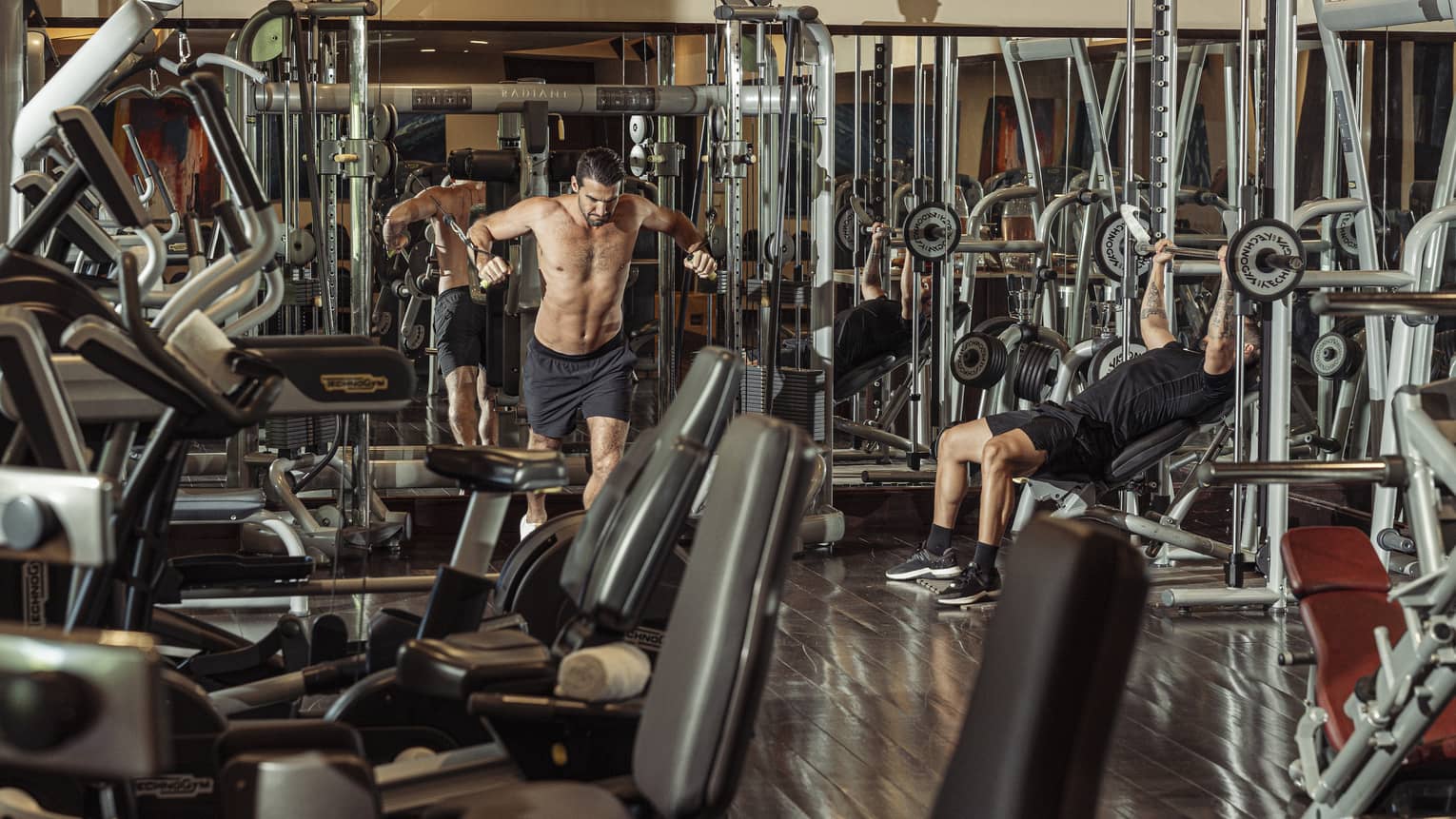 Two people working out on weight equipment in Fitness Centre