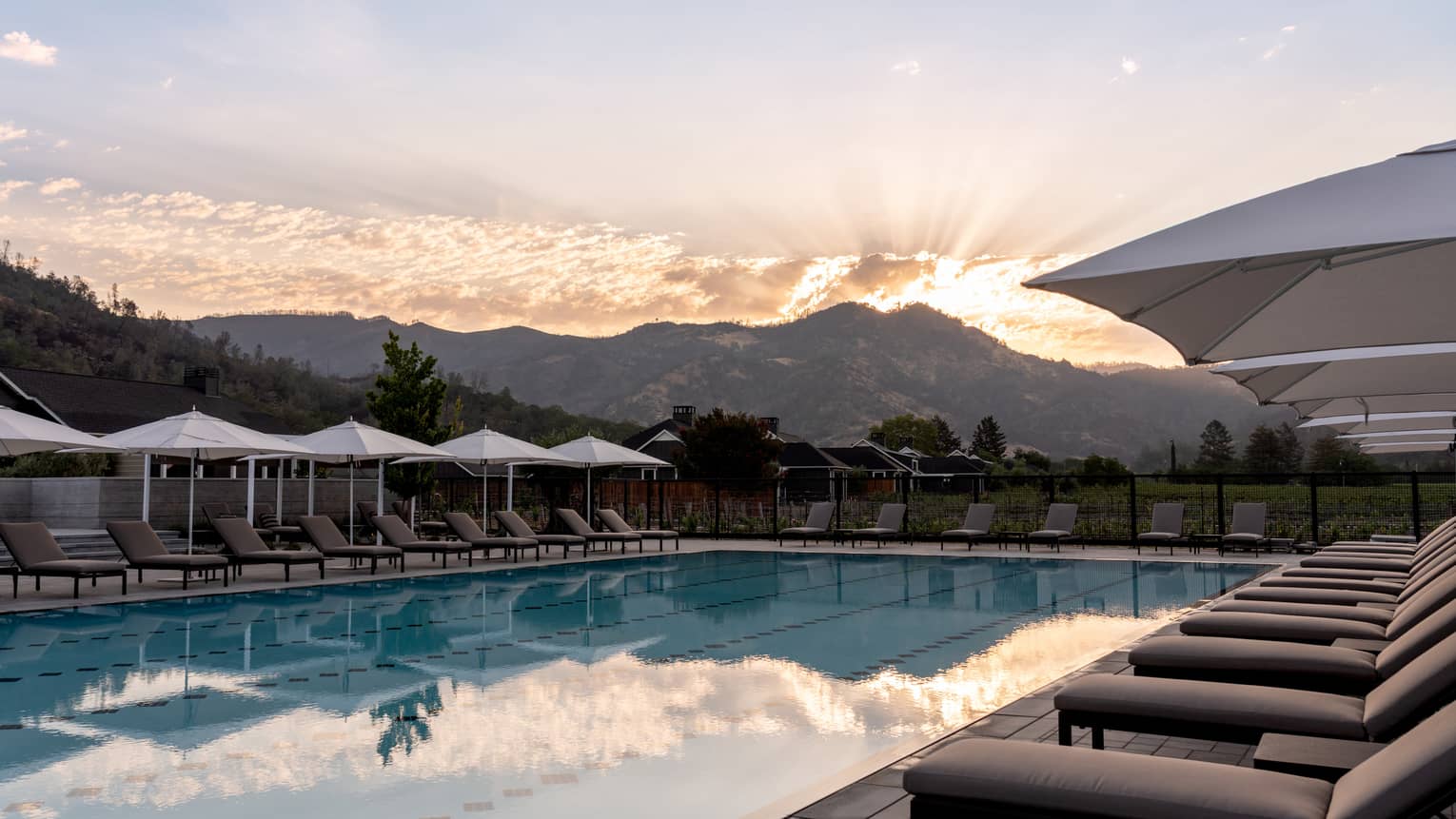 An outdoor pool with a mountain in the background.
