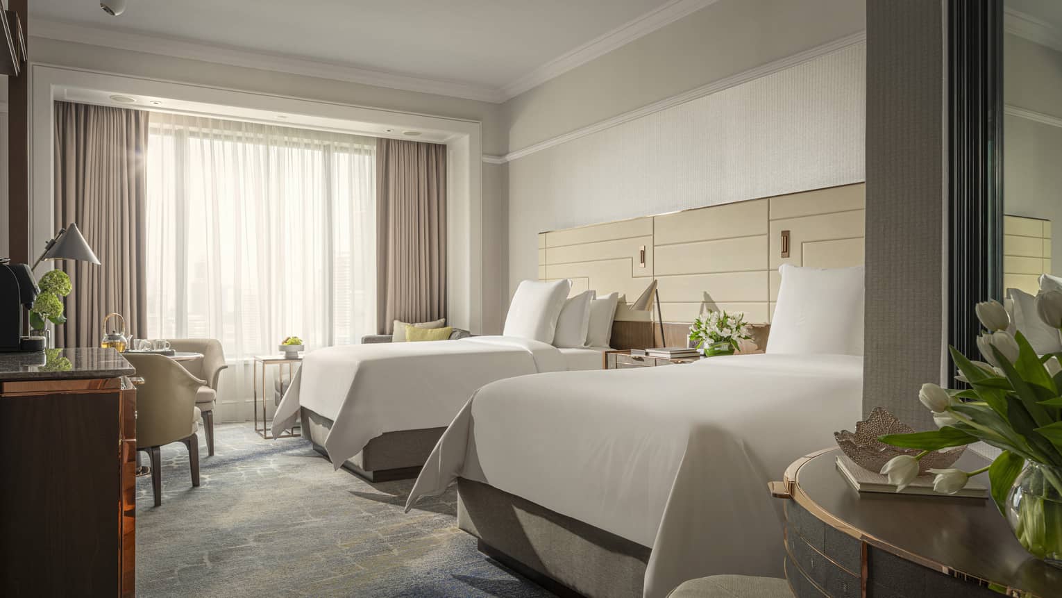 Hotel room with two twin beds, window, table and two chairs